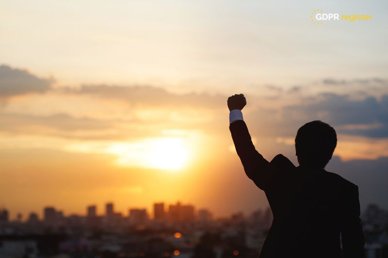 business leader celebrating GDPR compliance success, ensuring ethical data practices for sustainable business growth