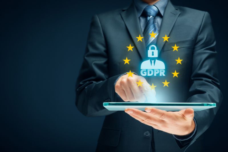 Business professional using a tablet with GDPR compliance icon, representing the role of a DPO